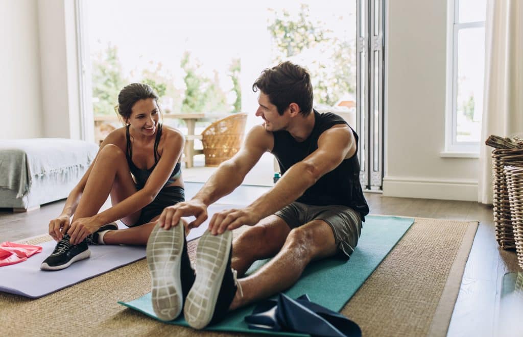 Couple exercising together at home