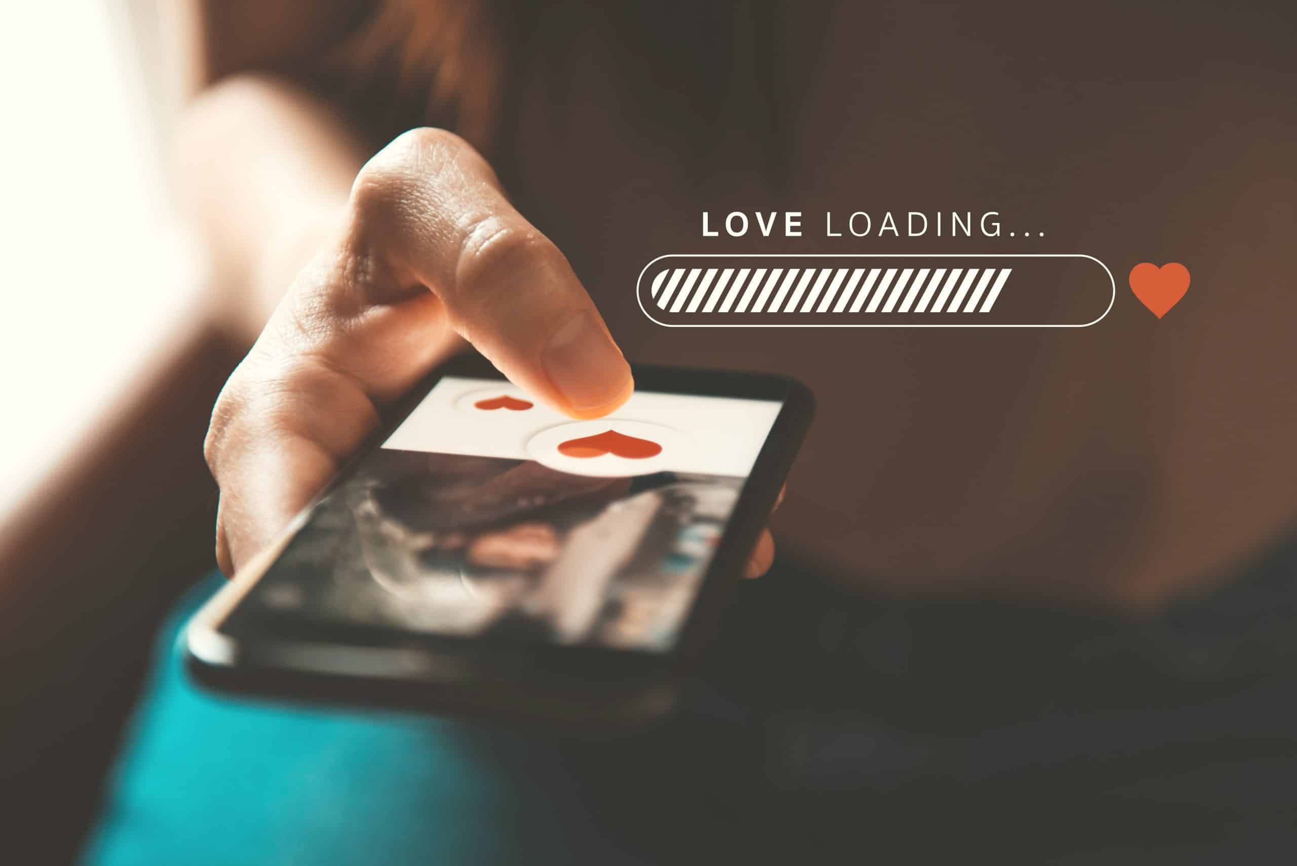 Love loading progress, Finger of woman pushing heart icon on screen in mobile smartphone application. Online dating app