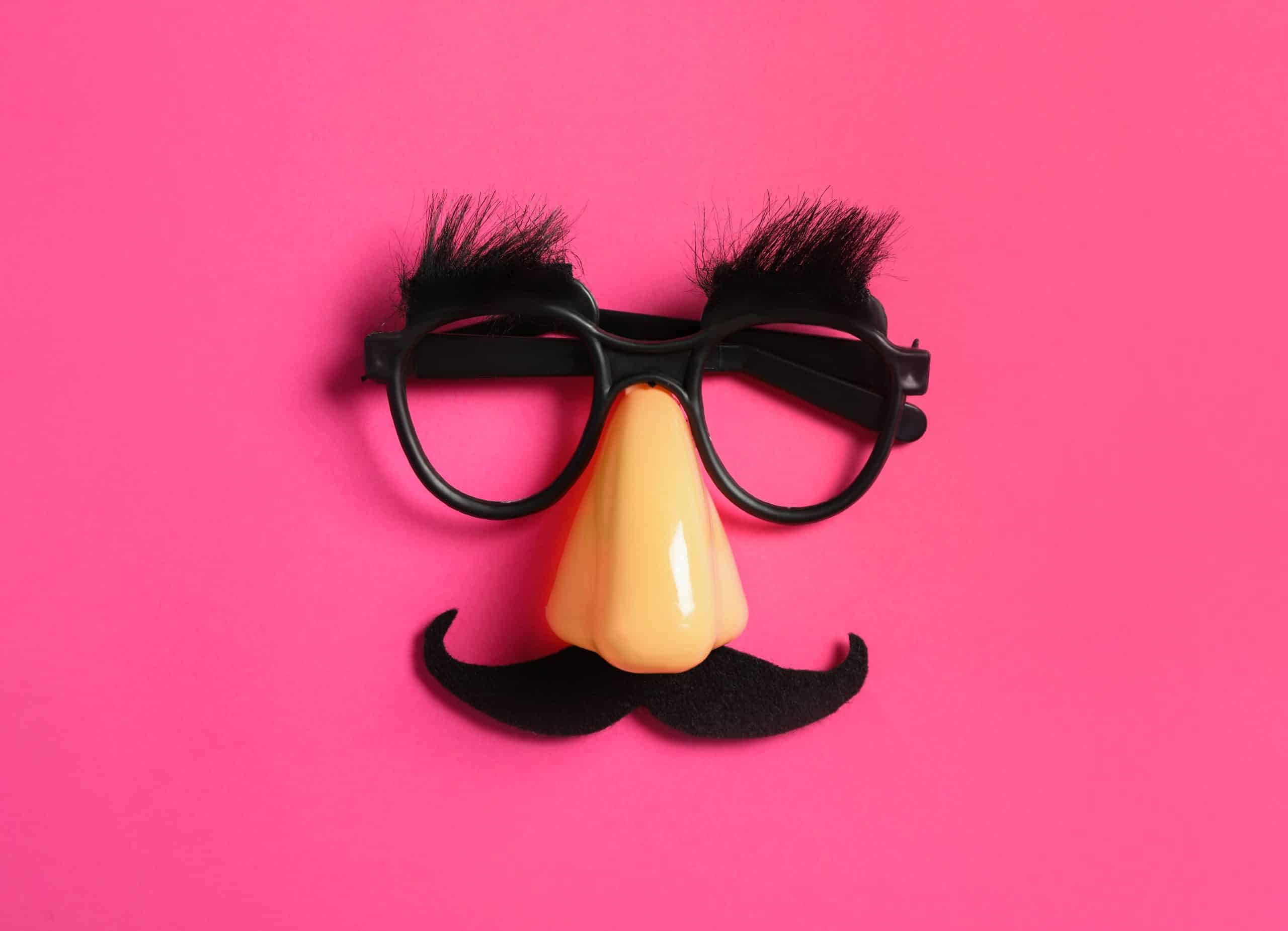 Funny glasses on pink background