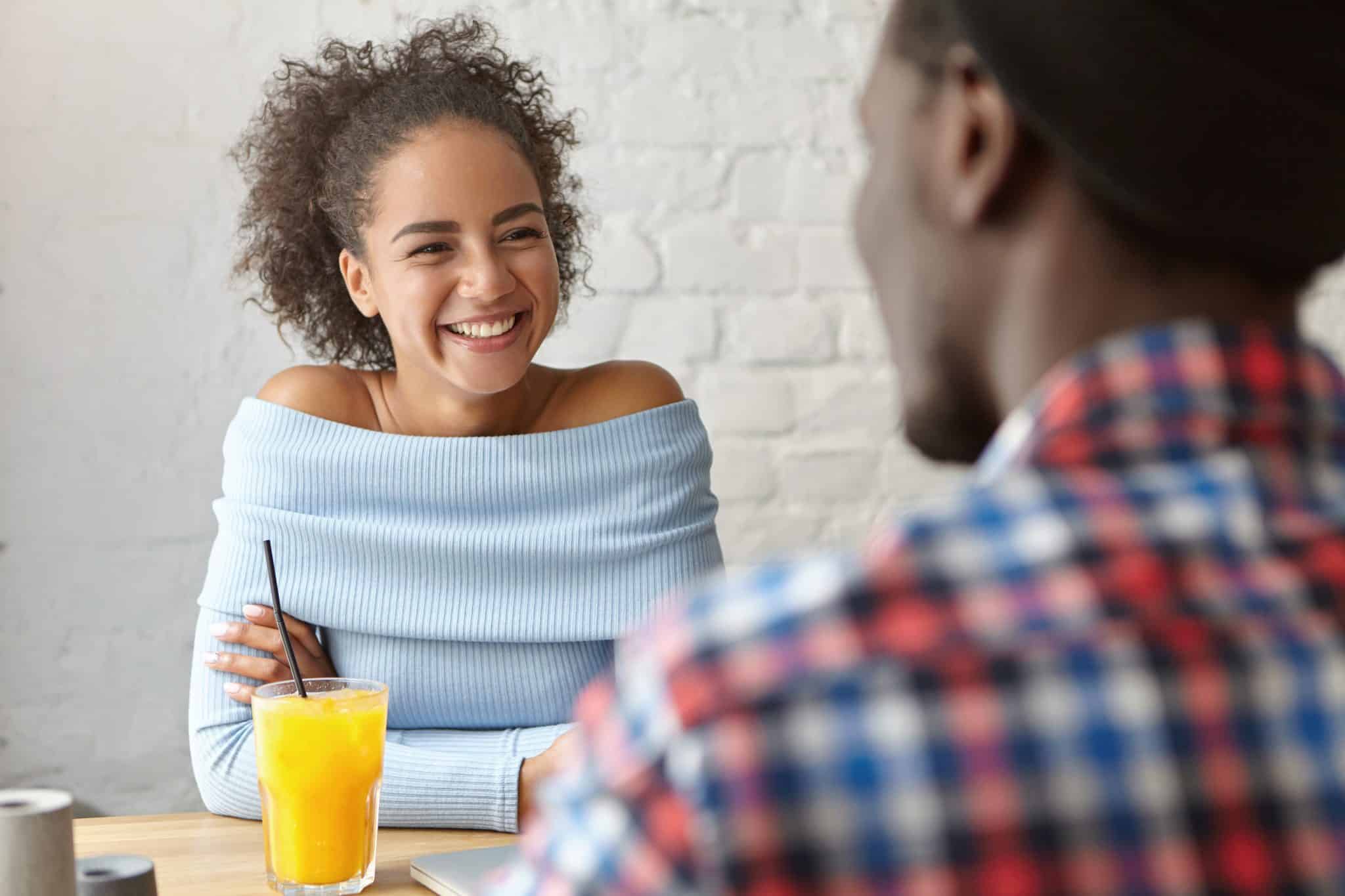 diverse couple talking to each other at restaurant