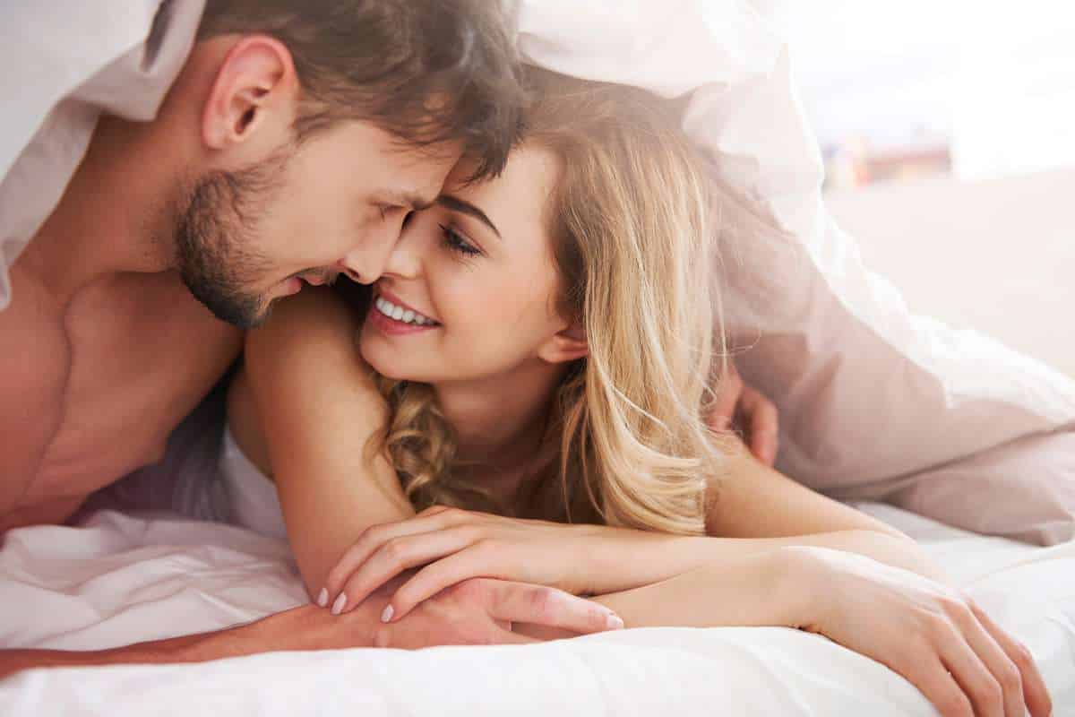 couple getting romantic in bed in the morning